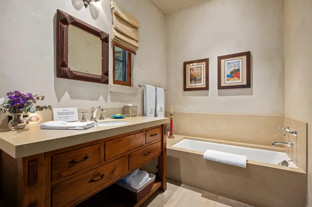 a bathroom with a double vanity sink mirror and shower
