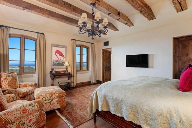 a room with table chairs and flat screen