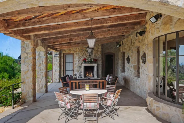 a view of a house with a yard patio and fire pit