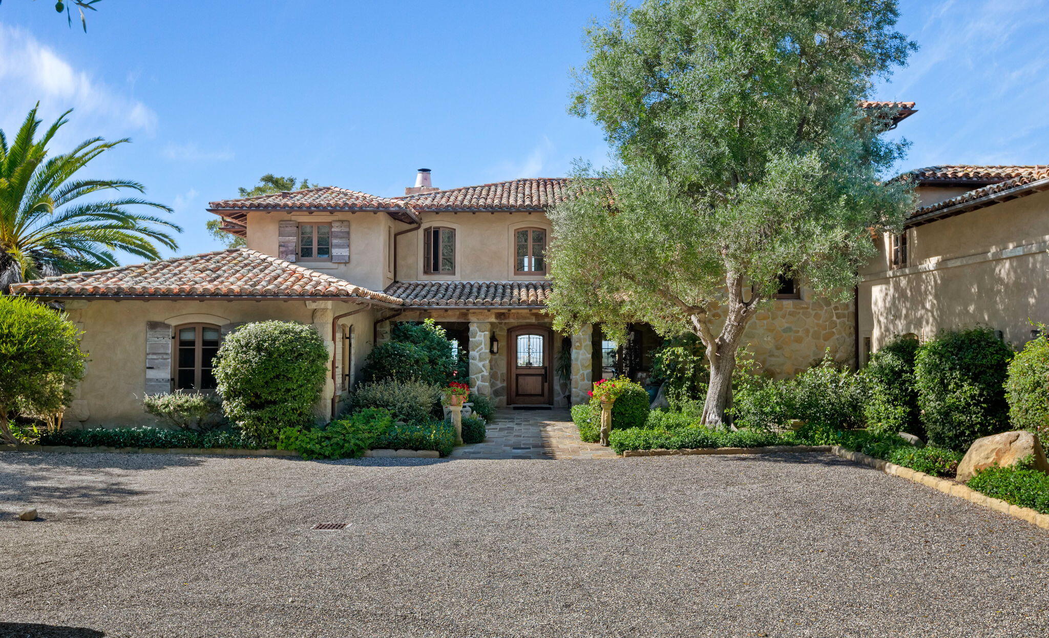 1915 Monte Allegro Drive Carpinteria, CA 93013 - Photo 5 of 59 a view of a house with a yard and plants