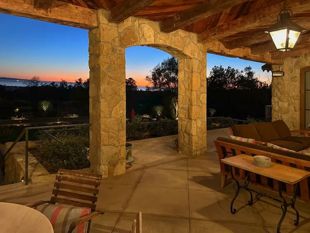 a front view of house with yard and mountain