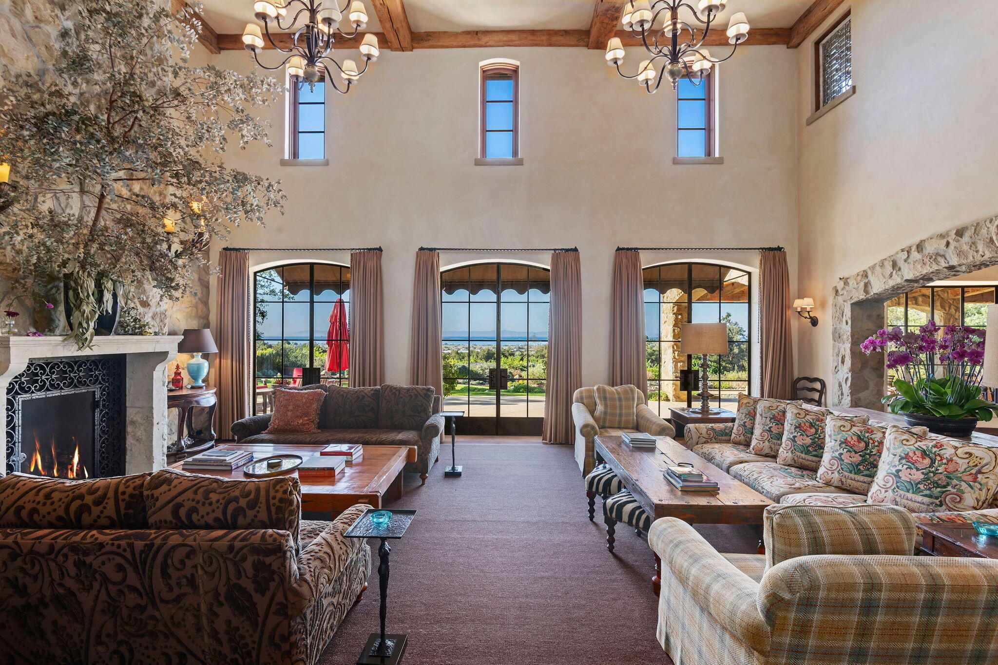 1915 Monte Allegro Drive Carpinteria, CA 93013 - Photo 8 of 59 a living room with furniture a fireplace and a chandelier