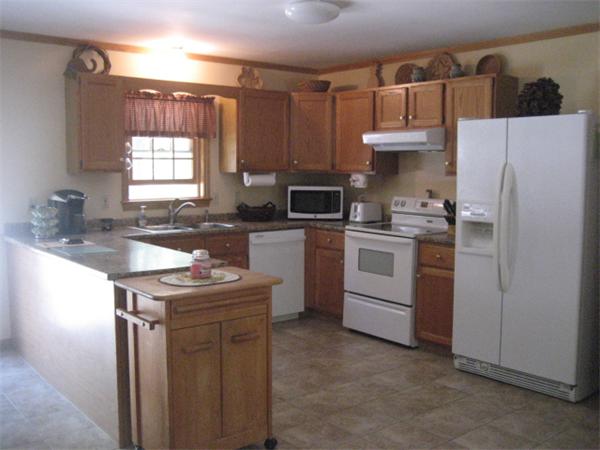 77 Hastings Road Ashburnham, MA 01430 - Photo 9 of 28 a kitchen with a sink a stove a refrigerator and a window