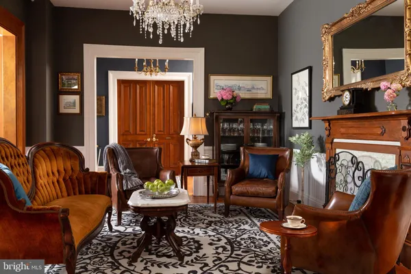 a living room with furniture and a mirror