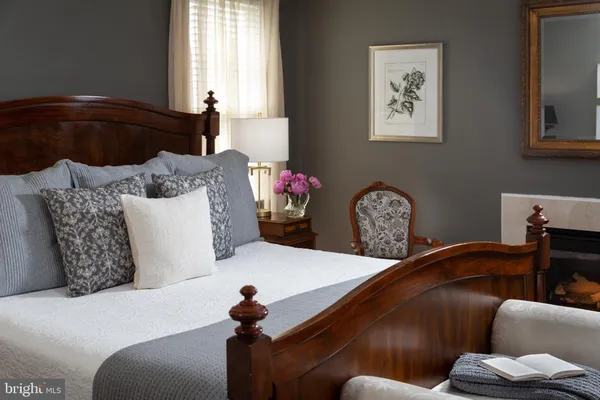 a bedroom with a bed a couch and dresser