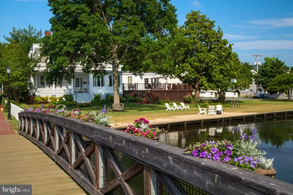 a view of swimming pool with wooden deck and furniture