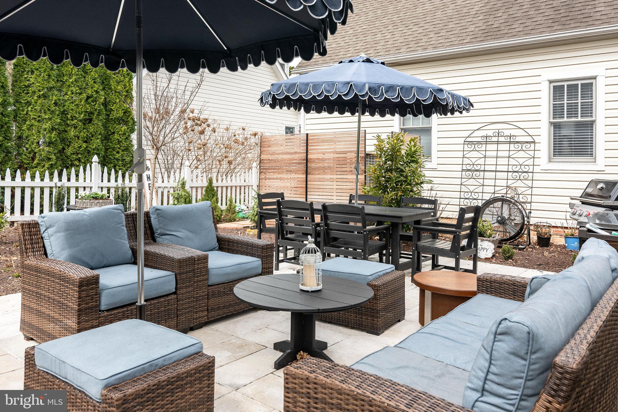 205 Cherry Street St. Michaels, MD 21663 - Photo 58 of 64 a view of a patio with couches under an umbrella