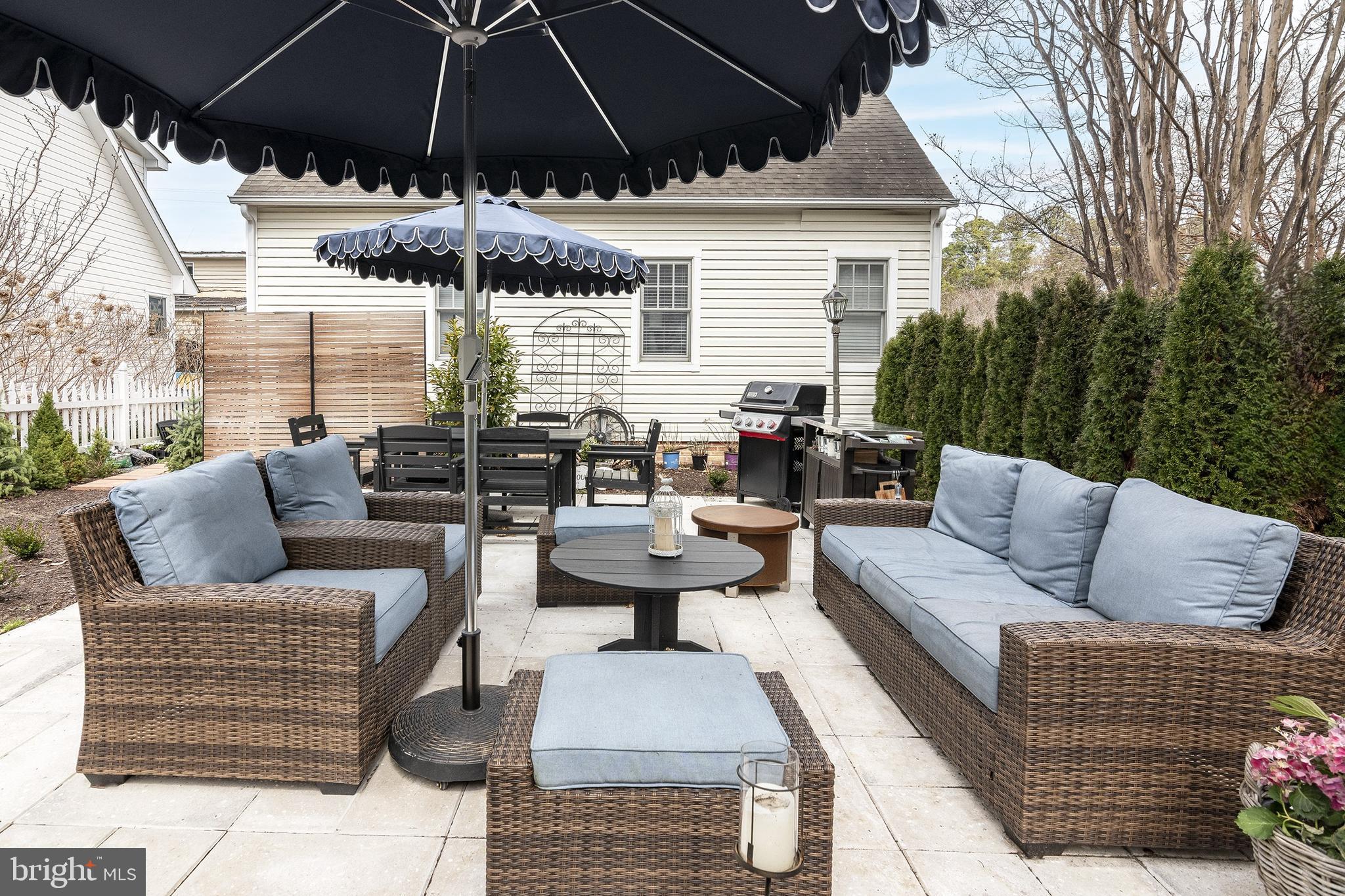 205 Cherry Street St. Michaels, MD 21663 - Photo 61 of 64 a view of a patio with couches and a umbrella