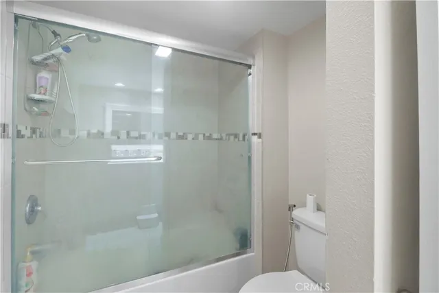 a bathroom with a shower and a toilet