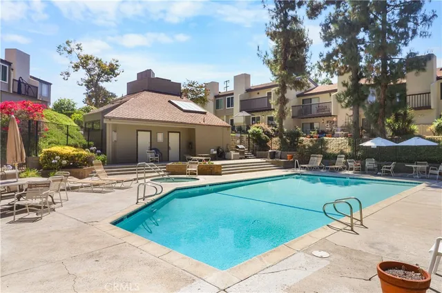 a view of a house with swimming pool and sitting area