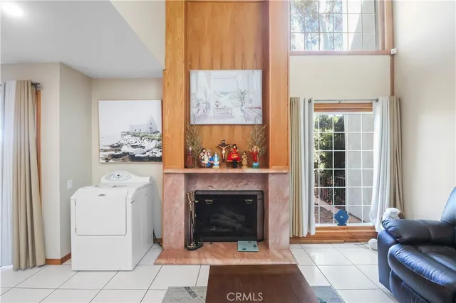 a living room with furniture a rug and a fireplace