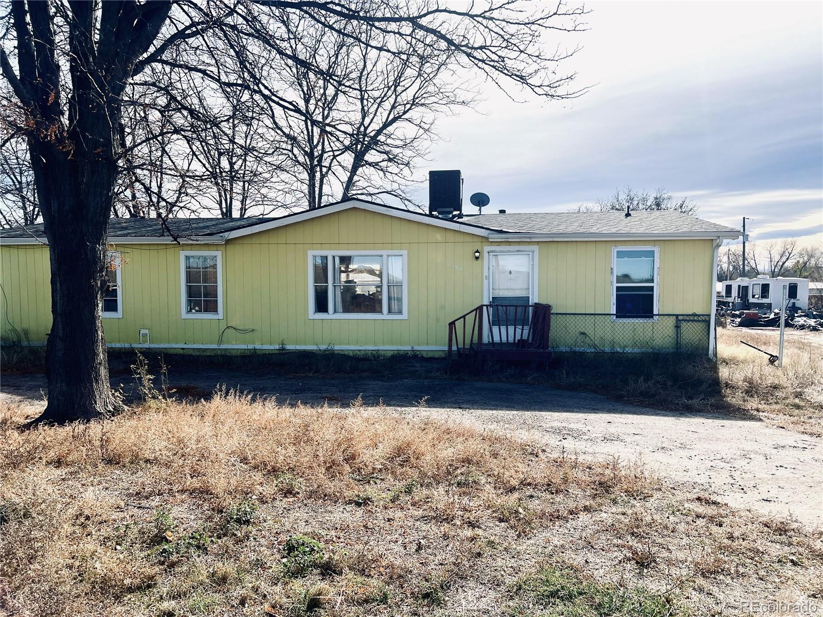 15544 County Road 18 Fort Lupton, CO 80621 - Photo 2 of 8 a front view of a house with garden