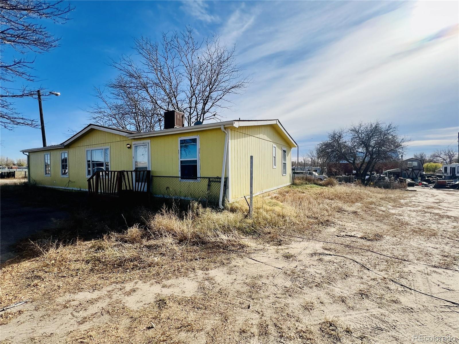 15544 County Road 18 Fort Lupton, CO 80621 - Photo 6 of 8 a view of a house with a yard