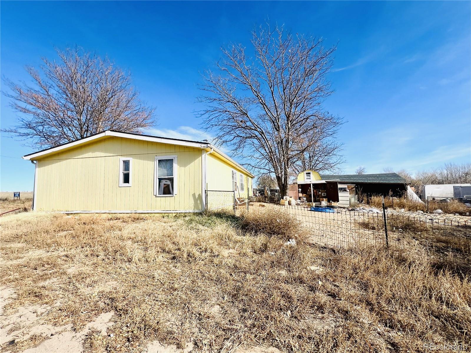 15544 County Road 18 Fort Lupton, CO 80621 - Photo 7 of 8 a view of a house with a yard