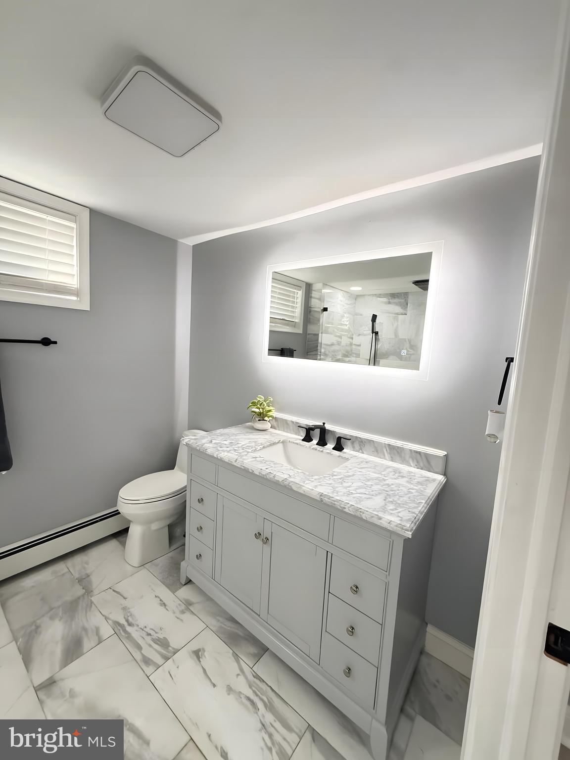 411 Arch Street Delran, NJ 08075 - Photo 20 of 28 a bathroom with a toilet a sink and mirror