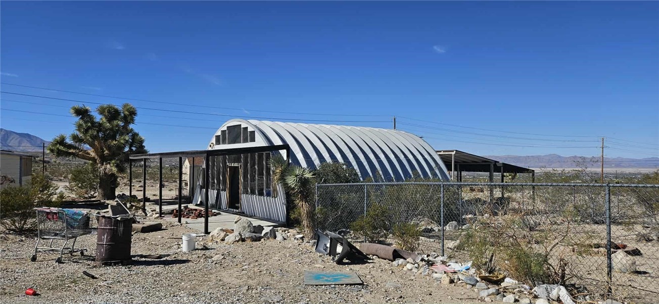 7535 Camp Rock Road Lucerne Valley, CA 92356 - Photo 26 of 62 a view of a terrace with chairs and iron fence
