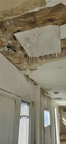 an aerial view of a backyard with plants and wooden bench