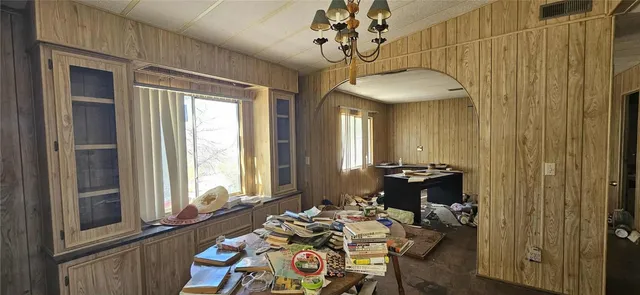 a kitchen with a granite countertop sink a stove and cabinets