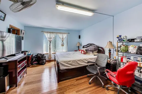 a bedroom with bed and window