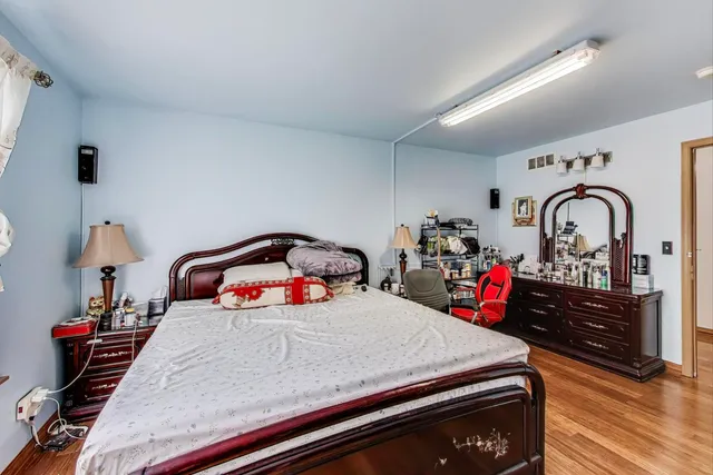a bedroom with bed and flat screen tv