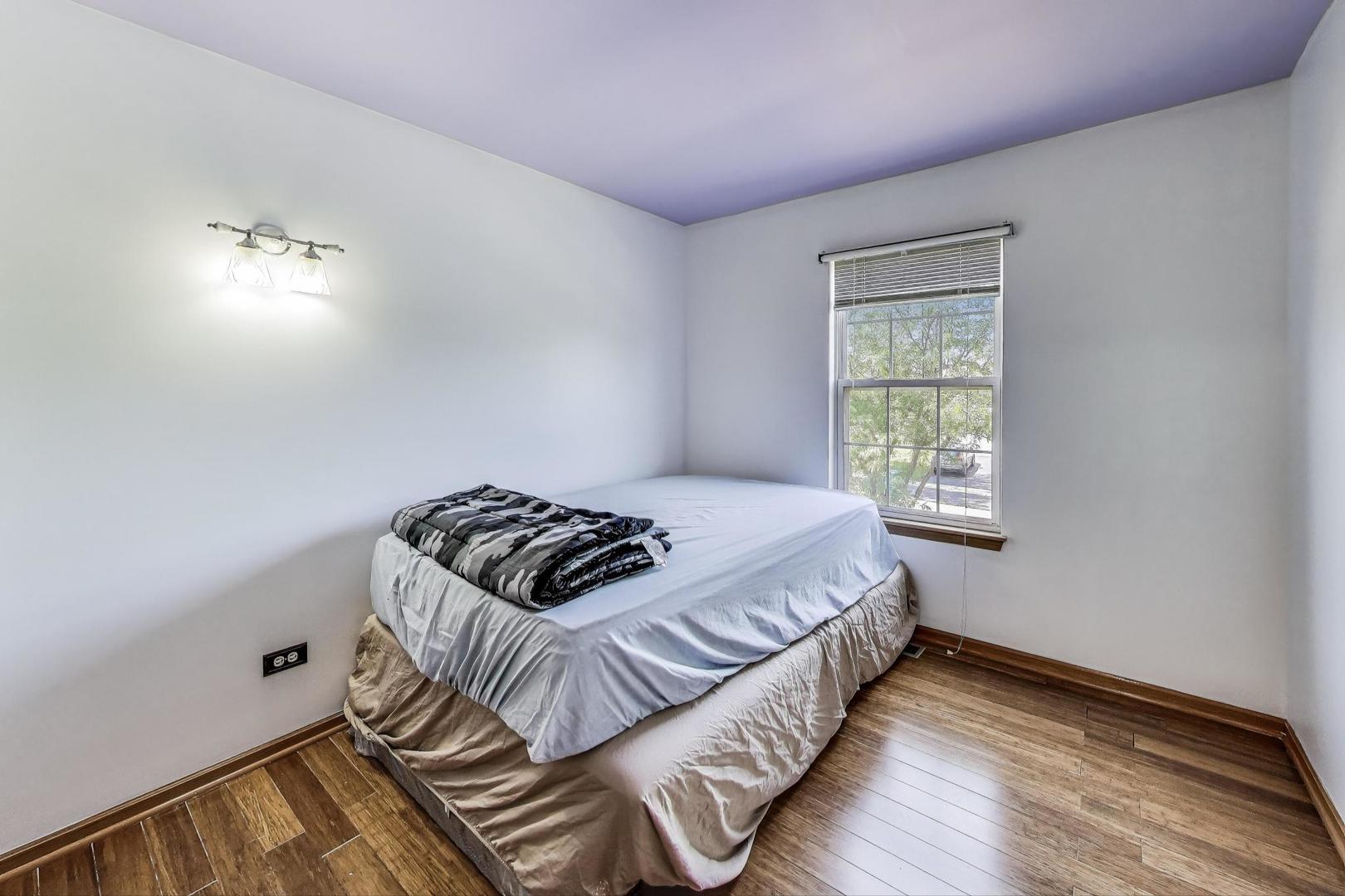 487 Anna Lane Romeoville, IL 60446 - Photo 21 of 38 a bedroom with a bed and a window