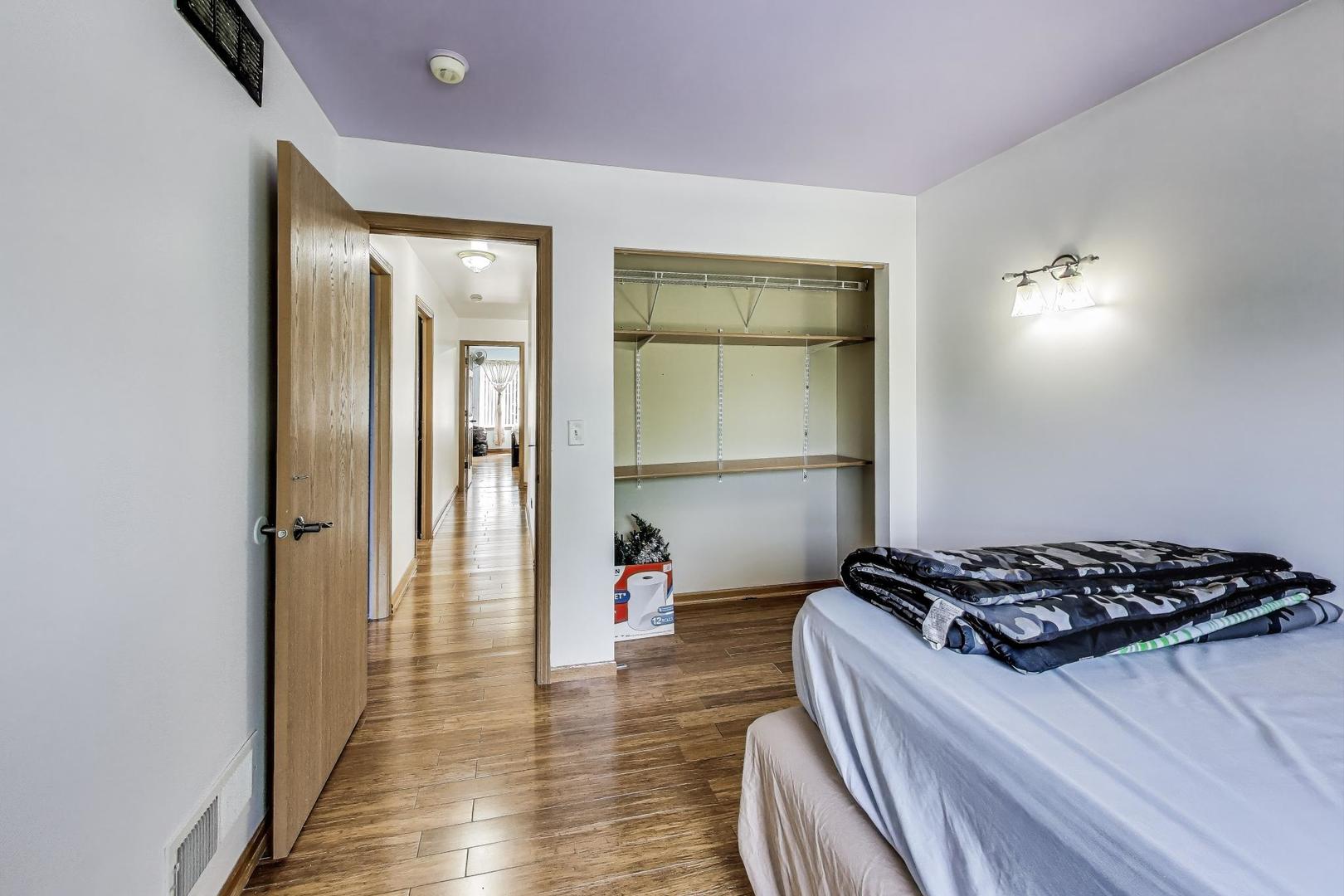 487 Anna Lane Romeoville, IL 60446 - Photo 22 of 38 a bedroom with a bed and a wooden floor