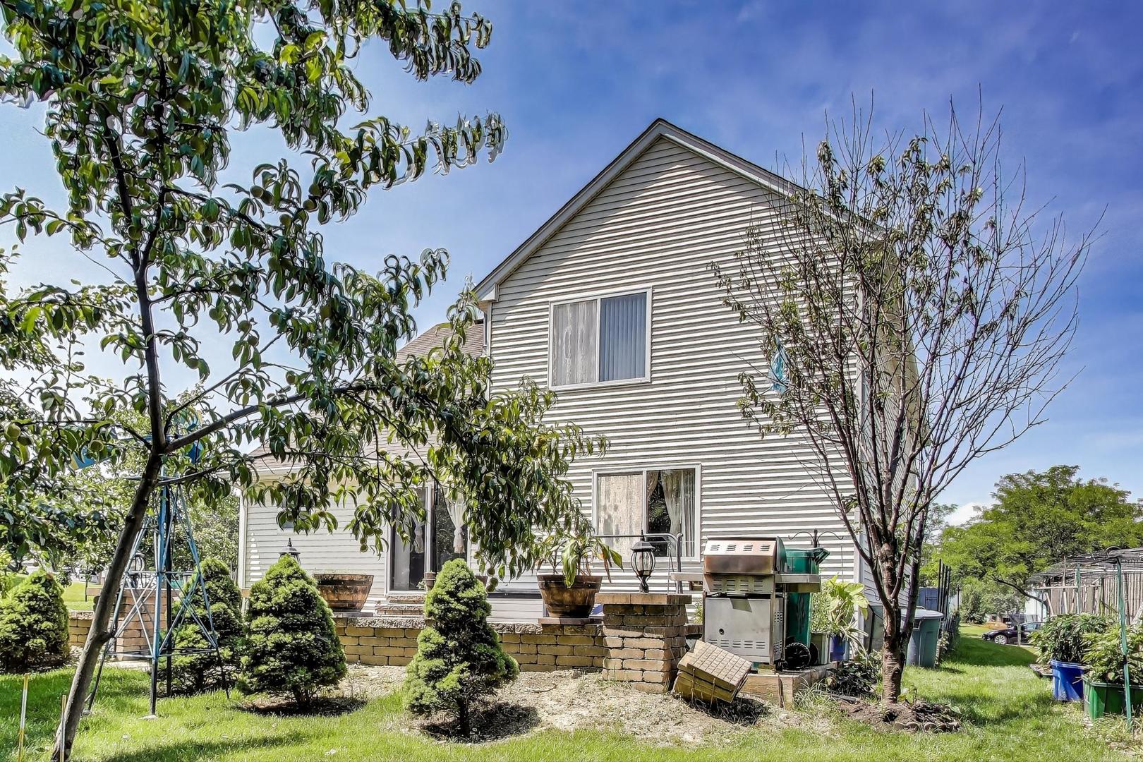 487 Anna Lane Romeoville, IL 60446 - Photo 29 of 38 a backyard of a house with barbeque oven and seating space