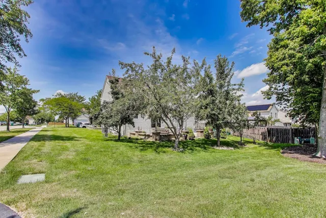 a view of a patio with a table and chairs and potted plants