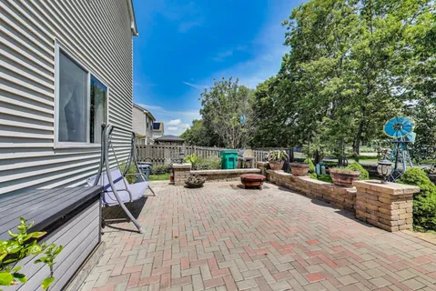 a view of a house with backyard and sitting area