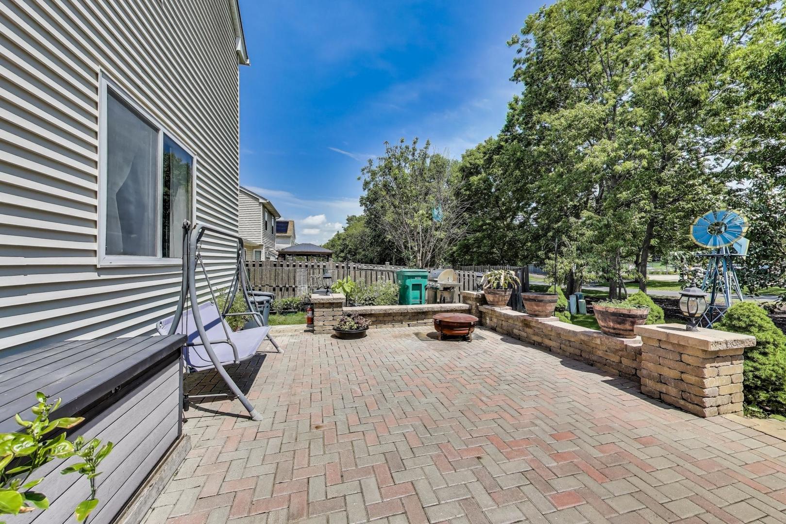 487 Anna Lane Romeoville, IL 60446 - Photo 32 of 38 a view of a patio with a table and chairs and potted plants