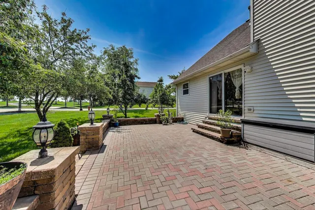 a view of a patio with dining table and chairs with wooden floor and fence