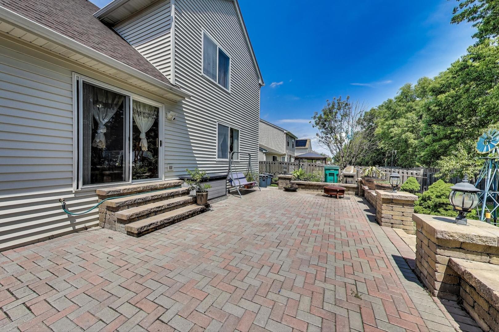 487 Anna Lane Romeoville, IL 60446 - Photo 34 of 38 a view of a patio with dining table and chairs with wooden floor and fence