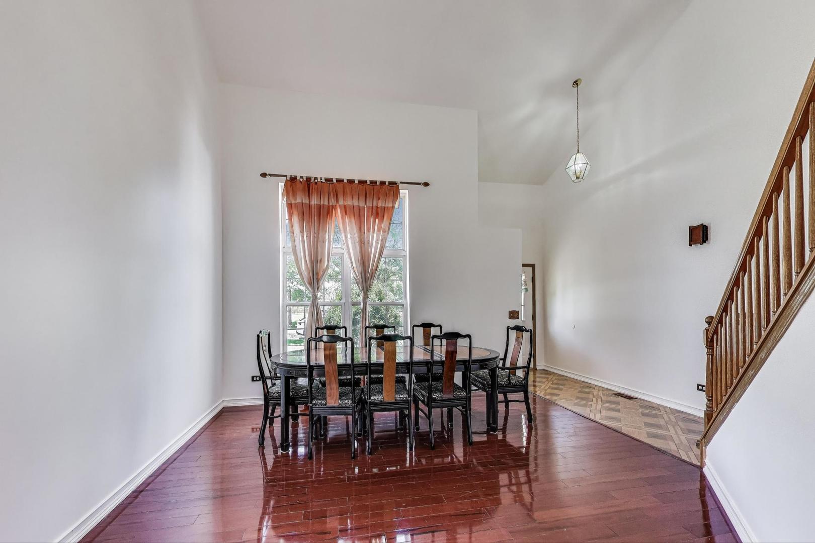 487 Anna Lane Romeoville, IL 60446 - Photo 5 of 38 a view of a dining room with furniture and wooden floor