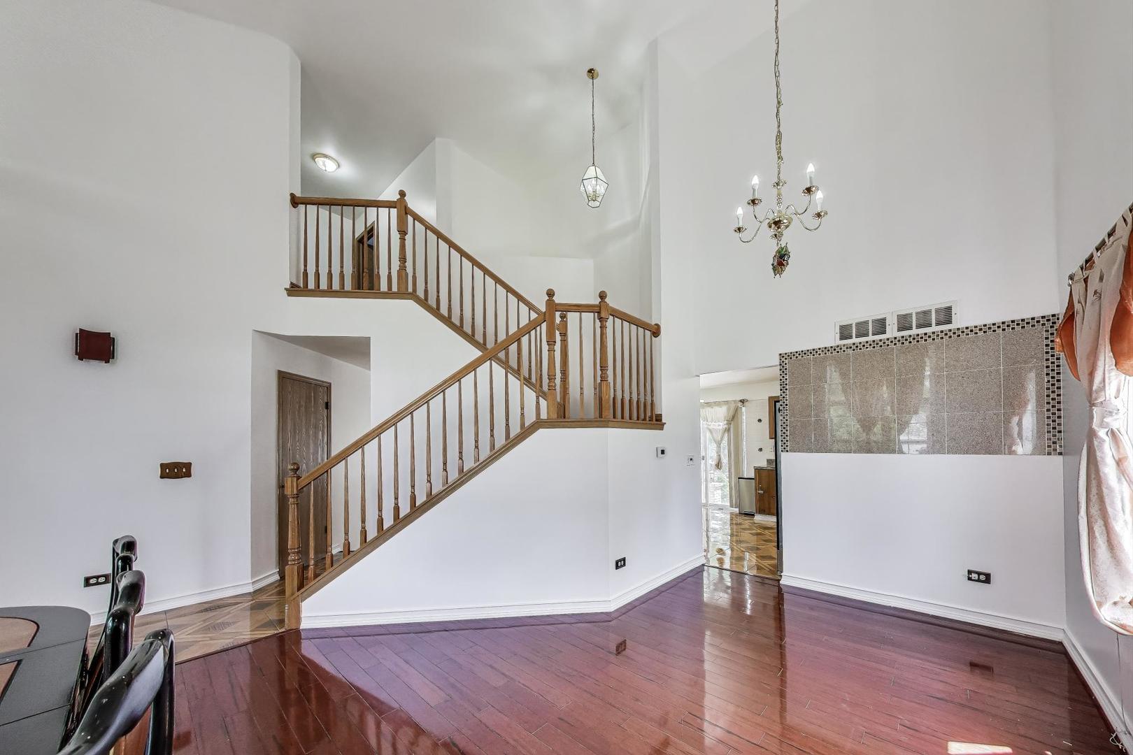 487 Anna Lane Romeoville, IL 60446 - Photo 7 of 38 a view of entryway and hall with wooden floor