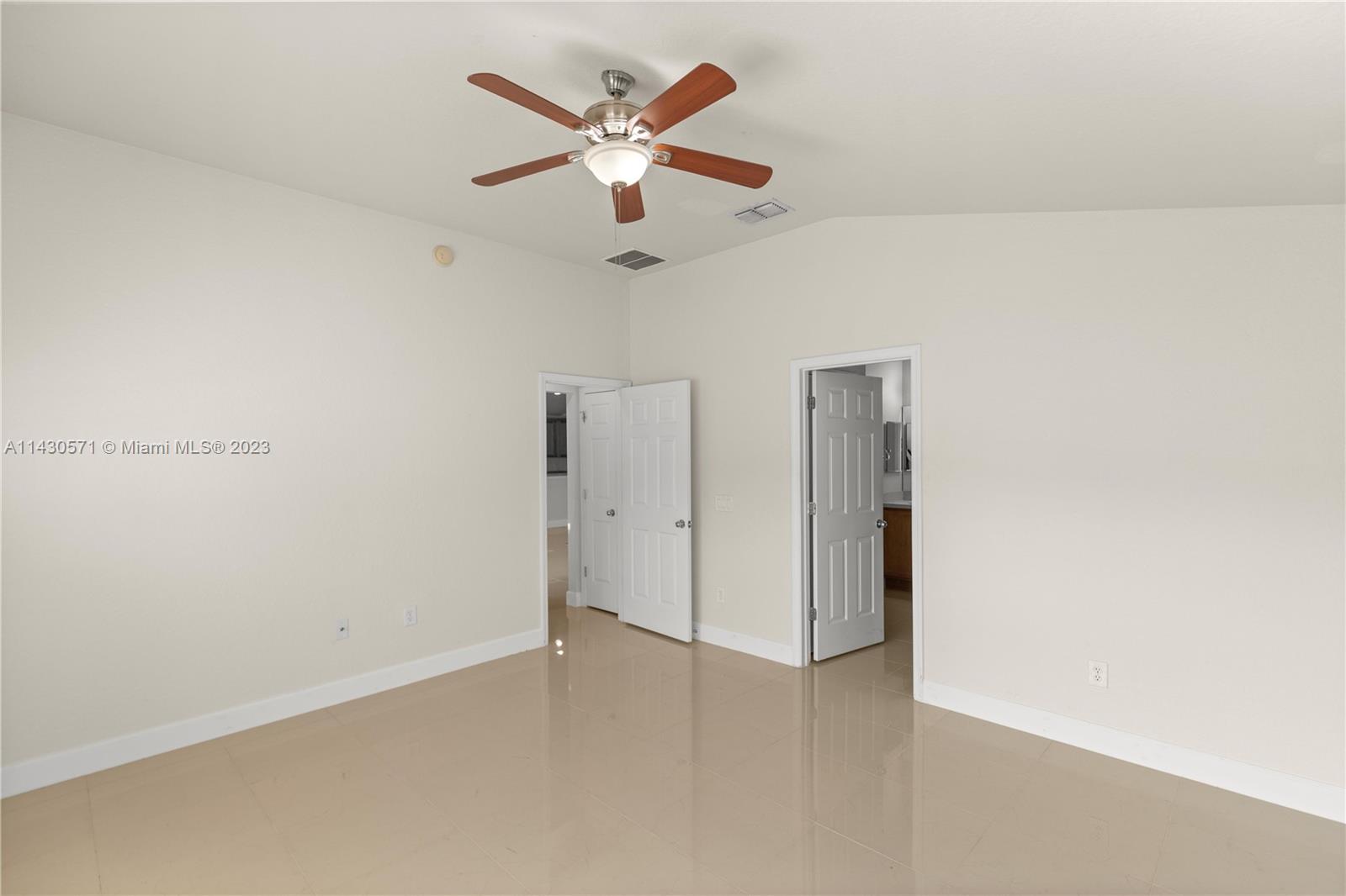 5453 Southwest 40th Street Ocala, FL 34474 - Photo 13 of 40 an empty room with a ceiling fan and a window