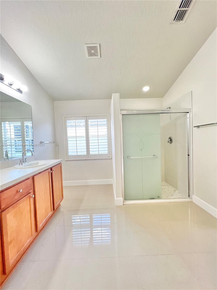 5453 Southwest 40th Street Ocala, FL 34474 - Photo 17 of 40 a bathroom with a bathtub and a shower