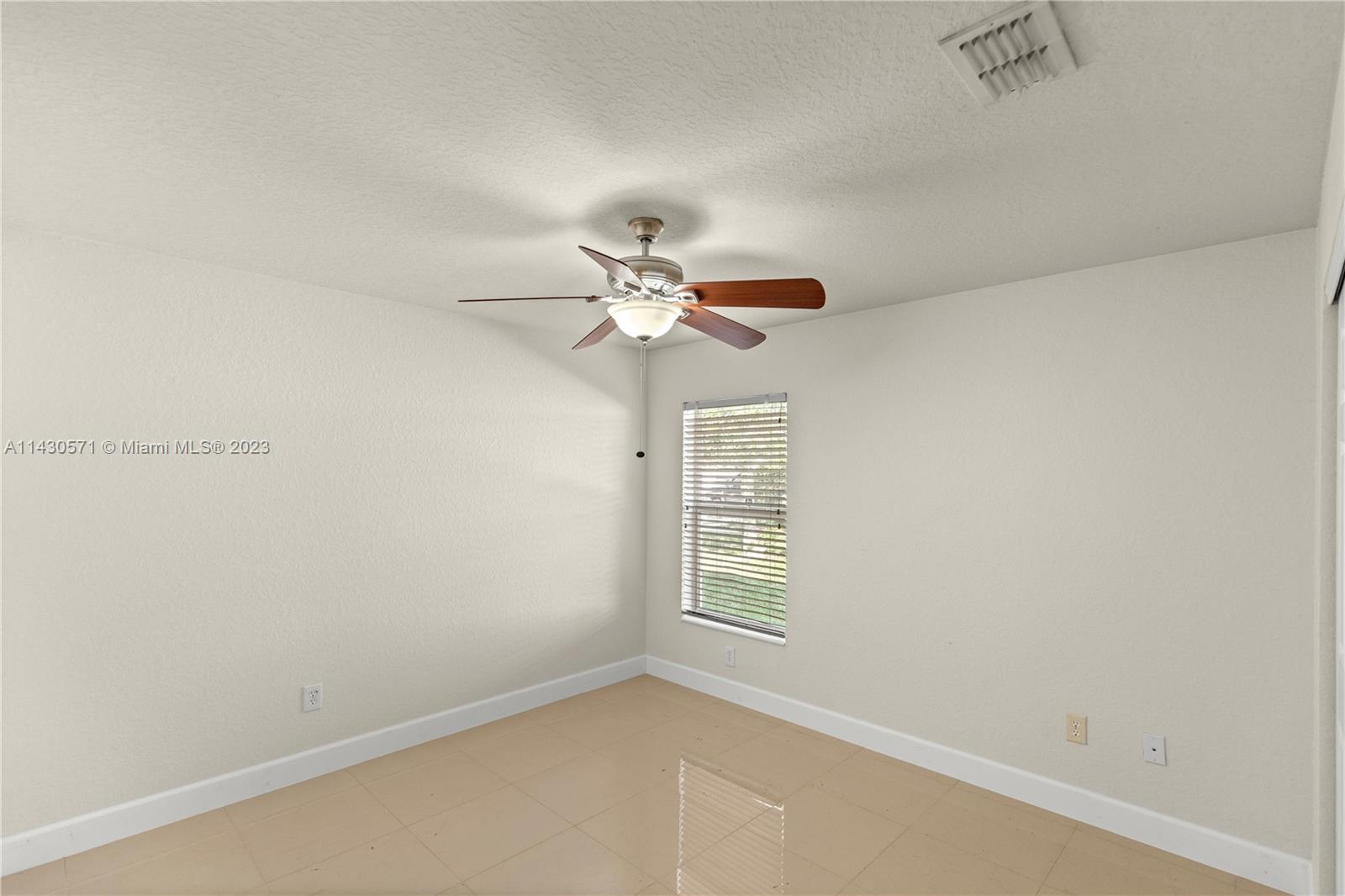 5453 Southwest 40th Street Ocala, FL 34474 - Photo 24 of 40 an empty room with windows and fan