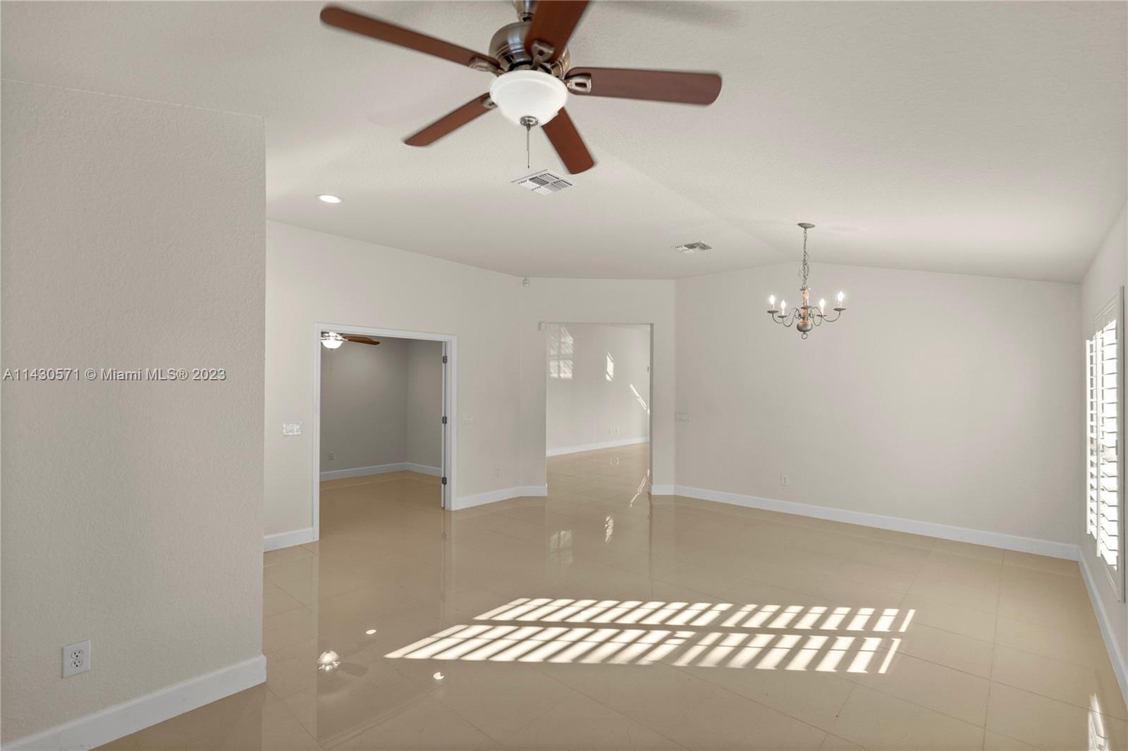 5453 Southwest 40th Street Ocala, FL 34474 - Photo 3 of 40 an empty room with wooden floor and windows