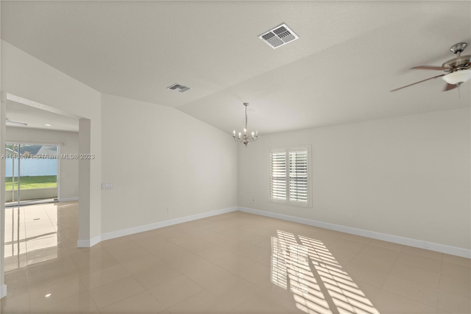 5453 Southwest 40th Street Ocala, FL 34474 - Photo 4 of 40 wooden floor in an empty room with a window