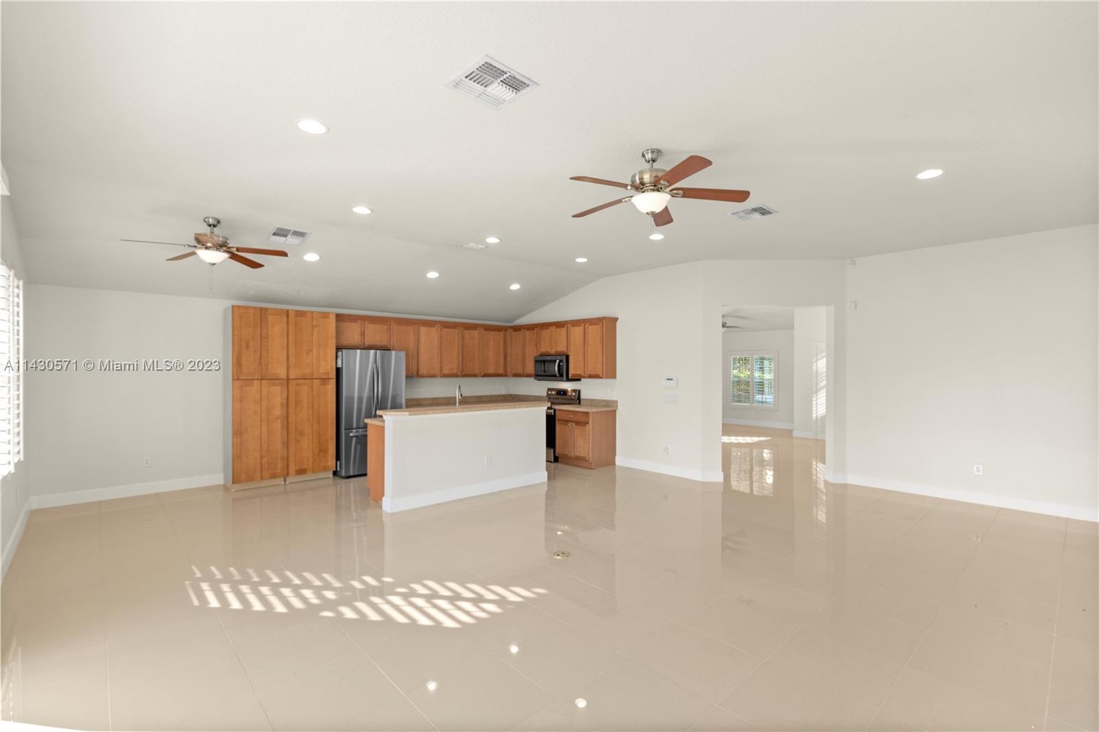 5453 Southwest 40th Street Ocala, FL 34474 - Photo 6 of 40 a view of a kitchen with a sink and a refrigerator