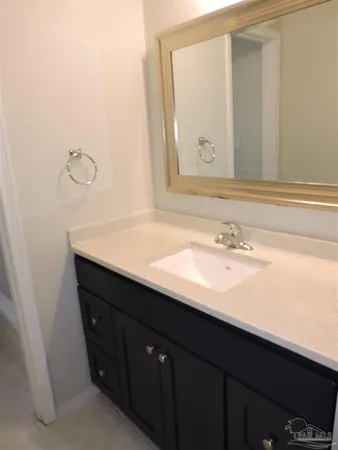 a bathroom with a sink vanity and a mirror