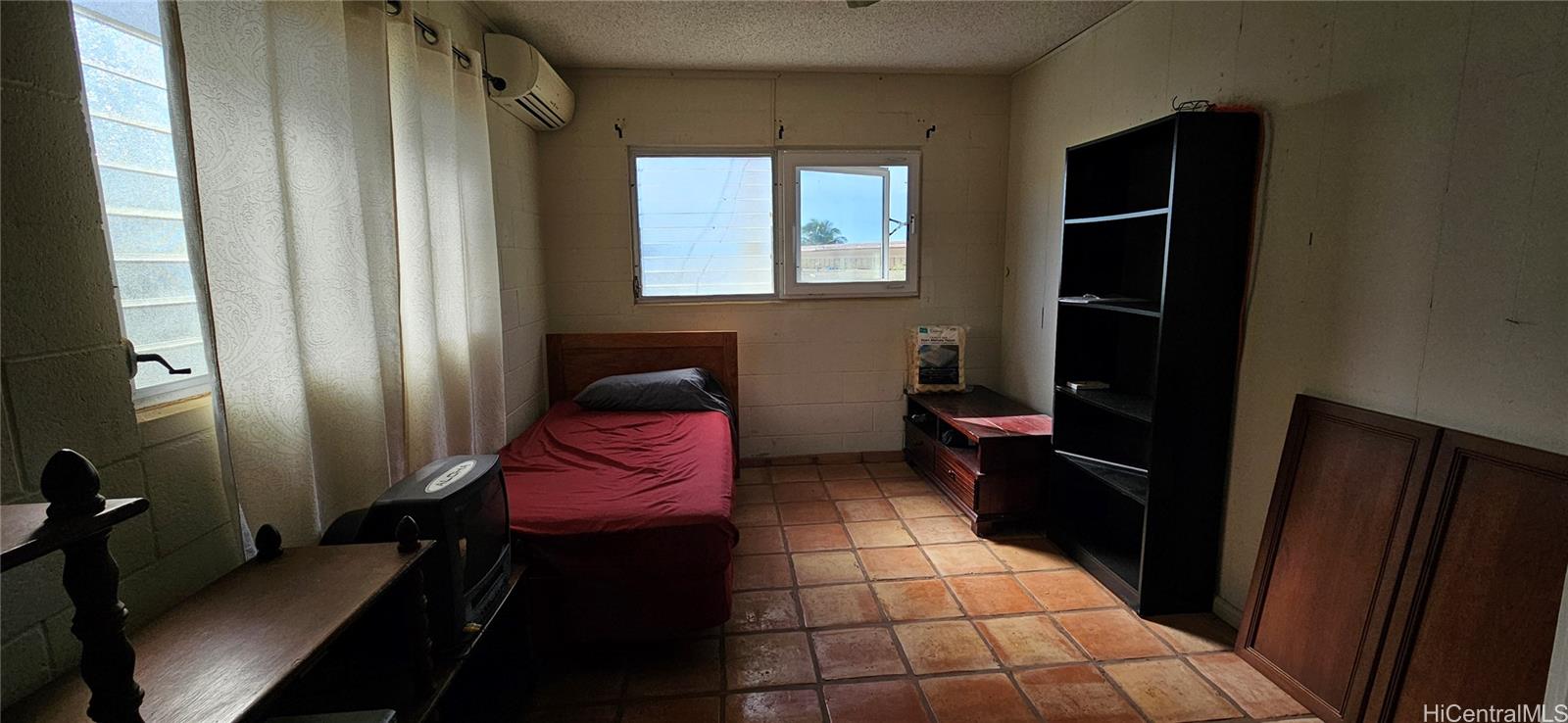 28 Poipu Drive Honolulu, HI 96825 - Photo 4 of 7 a living room with a black white checkered floor