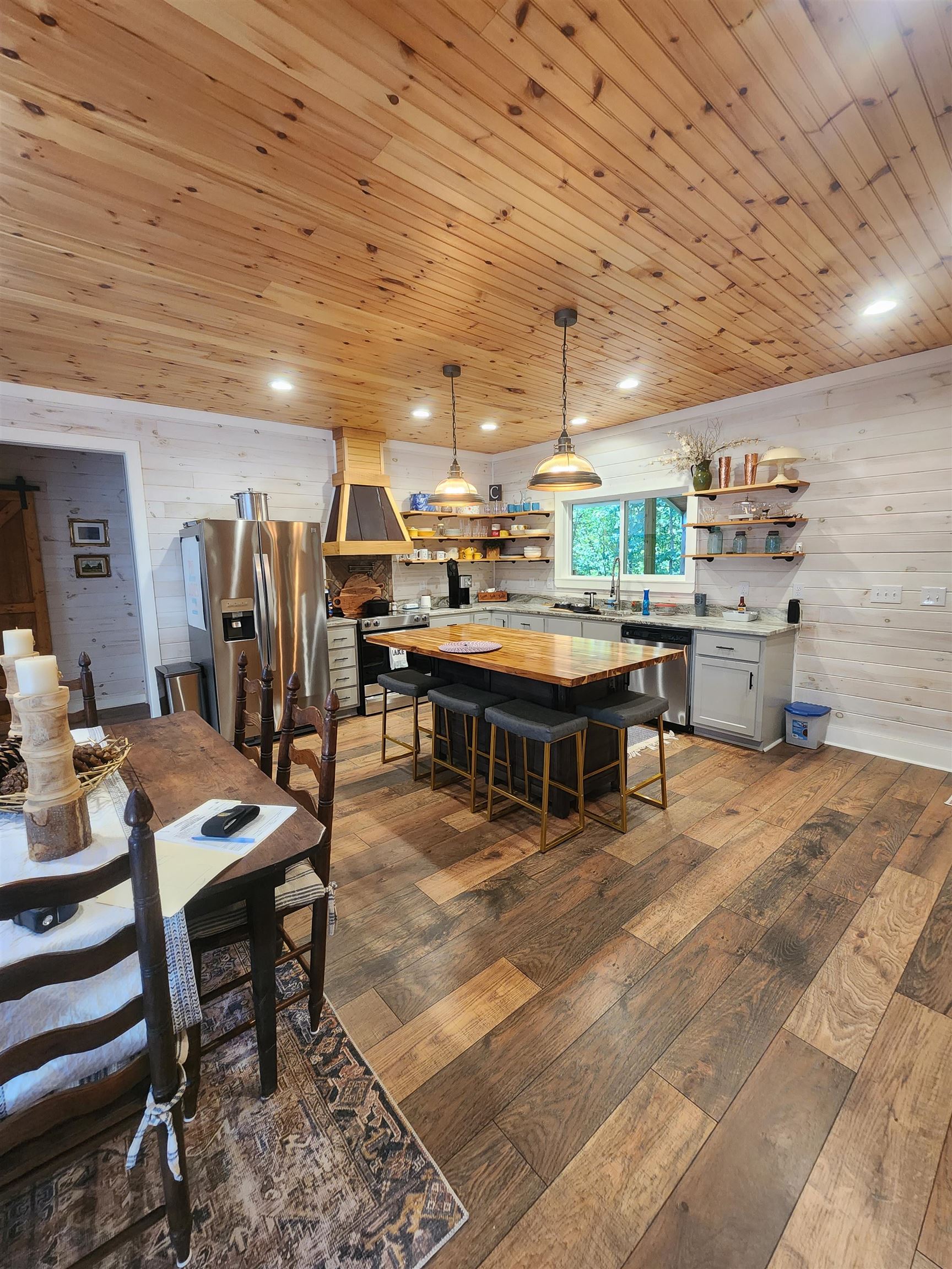 540 Muscatel Lane Counce, TN 38326 - Photo 6 of 35 a room with stainless steel appliances kitchen island granite countertop a table chairs and a refrigerator