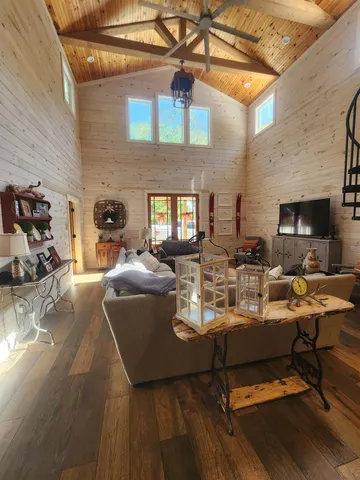 a living room with fireplace furniture and a wooden floor