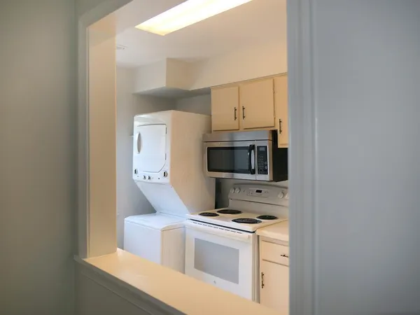 a kitchen with stainless steel appliances a stove a microwave and a refrigerator