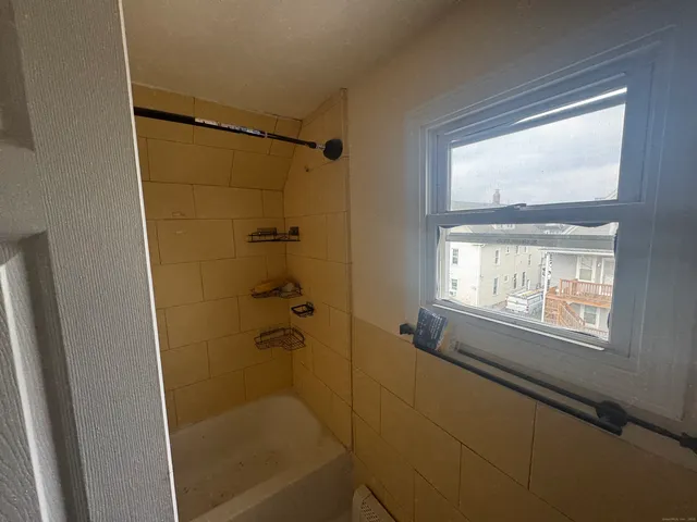 a bathroom with a glass shower door