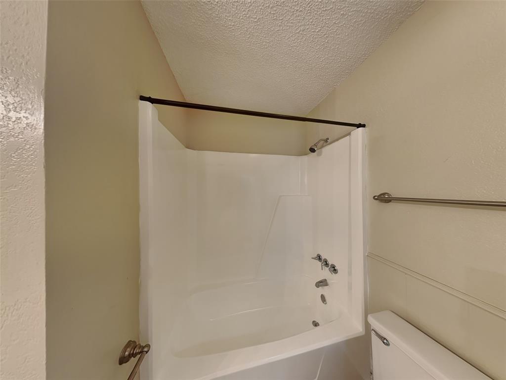 852 Northwest Summercrest Boulevard, Unit B Burleson, TX 76028 - Photo 11 of 13 a bathroom with a bathtub