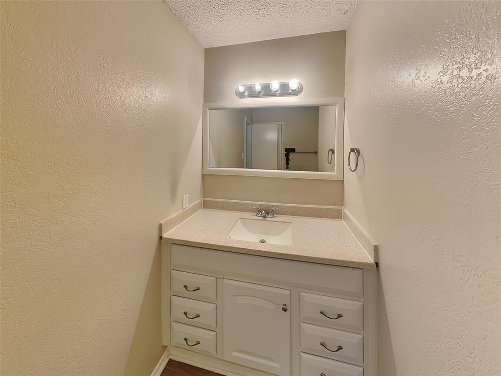 852 Northwest Summercrest Boulevard, Unit B Burleson, TX 76028 - Photo 12 of 13 a bathroom with a sink and a mirror