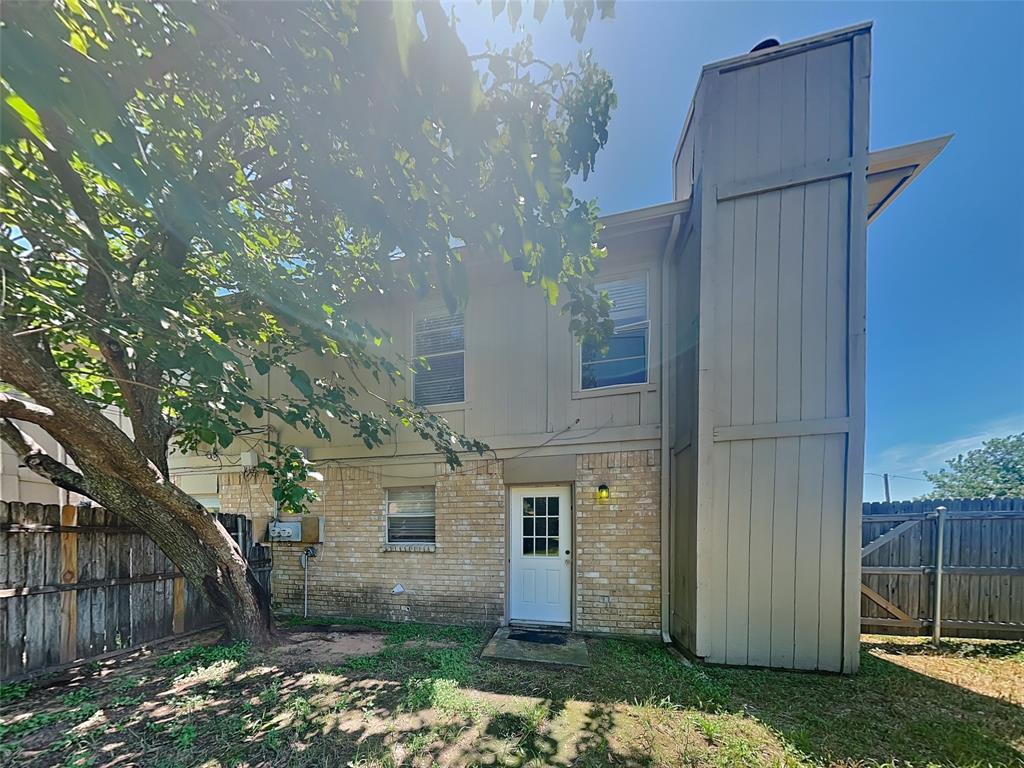 852 Northwest Summercrest Boulevard, Unit B Burleson, TX 76028 - Photo 13 of 13 a view of a house with a yard
