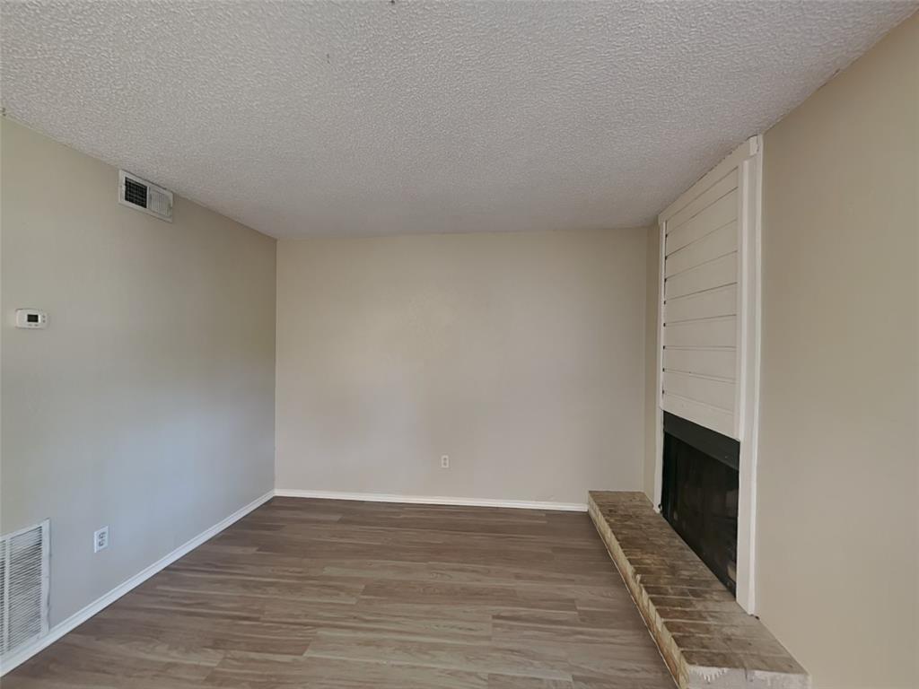 852 Northwest Summercrest Boulevard, Unit B Burleson, TX 76028 - Photo 2 of 13 a view of a livingroom with wooden floor and a staircase